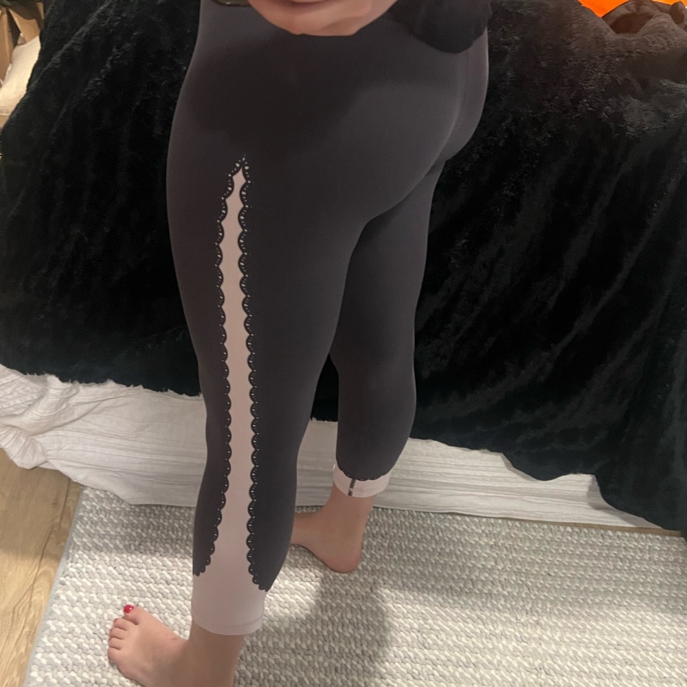 Athleta leggings. Gray/purple color with light pink “lace” detail down sides.